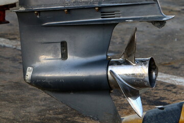 The propeller of a motor boat at the pier in the seaport.