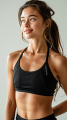 Obraz premium a female fitness influencer, exuding charisma and positivity, dressed in trendy workout attire, against a minimalist backdrop