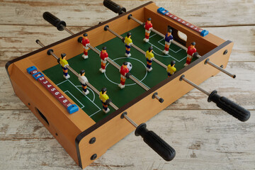 Mini table football on the table, table football on a wooden table, table sports game in football