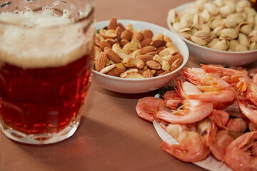 Beer in a glass and snacks, blur