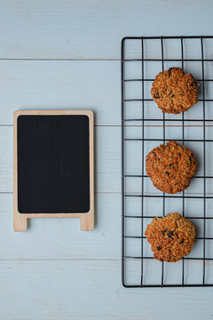 Litte chalkboard mockup with 3 three oatmeal cookies on cooling rack