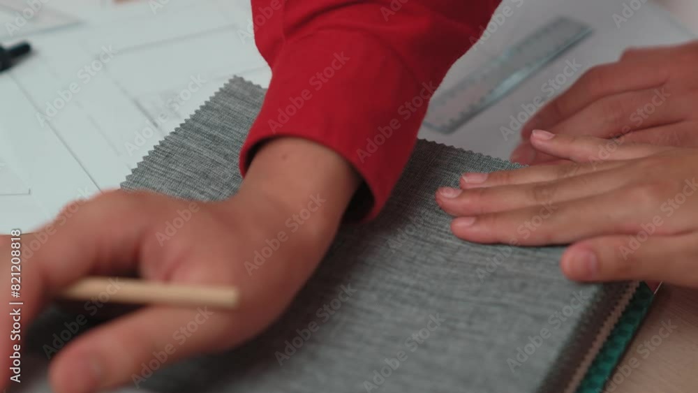 Aufkleber hand closeup architect and interior designer presenting textile material and color from color palett