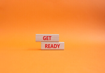 Get ready symbol. Wooden blocks with words Get ready. Beautiful orange background. Business and Get...