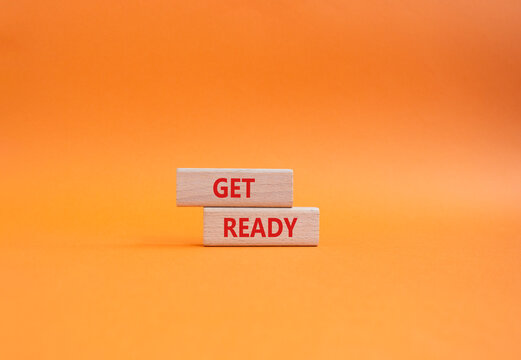 Get ready symbol. Wooden blocks with words Get ready. Beautiful orange background. Business and Get ready concept. Copy space.