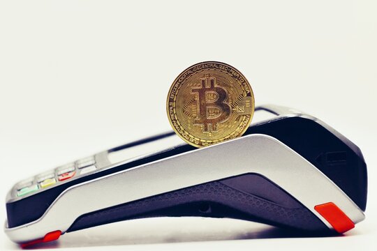 Payment terminal ready to accept bitcoins for payment. Gold bitcoin inside.