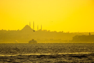 Istanbul view at sunset. Suleymaniye Mosque and ferry on the bosphorus
