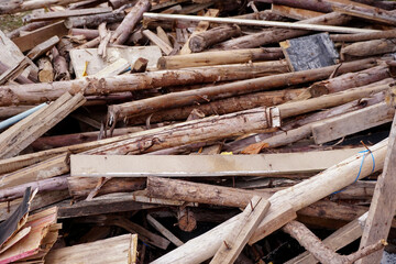 Pile of wood timber with nail waiting for reuse. Wood planks texture background, Close up.