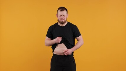 Overweight Male Stomach

Young man with a naked, overweight belly shaking fat folds on his stomach. Represents obesity, health issues, and beer belly. Ideal for health-related projects and discussions