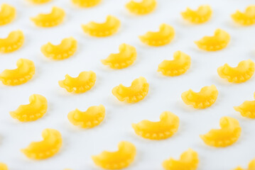 Pattern dry Italian pasta Creste Di Gallo on a white background. Rooster scallop.