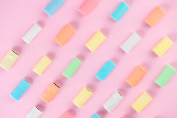 Pattern of colorful chewing candies with licorice on a pink background. Swedish candy. Top view.