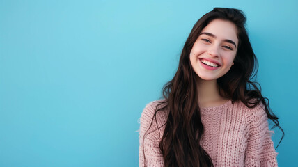 Fototapeta premium joyful young woman standing against a blue background