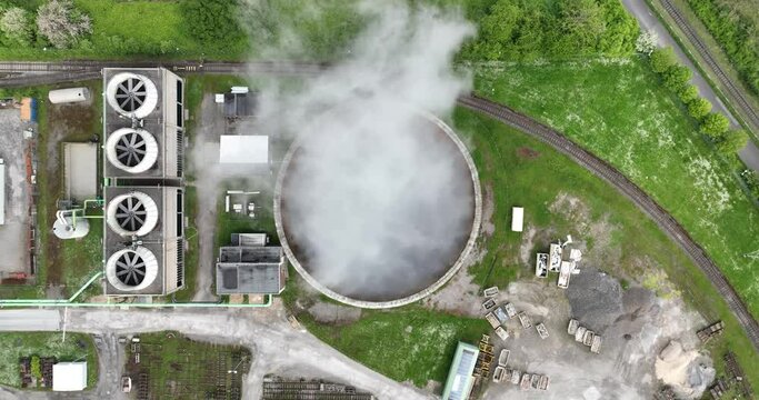 Aerial drone view of a smoking smokestack at a chemical park in Rheinberg, North Rhine Westphalia, Germany.