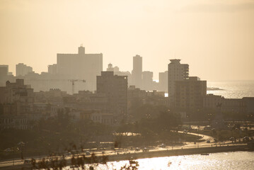 view of the city from above the embankment, Havana, ancient city, historical buildings, capitol, sunset on the embankment, golden hour in Havana