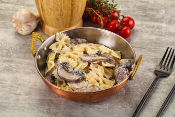 Italian cuisine - farfalle with mushrooms