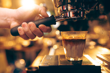 Professional Barista Prepares Fresh Cappuccino in a Busy Cafe: Closeup of Hands Skillfully Using...