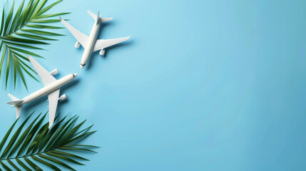 Two toy airplanes against a blue background with palm leaf, concept vacation, travel, banner, copy space