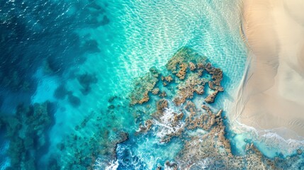 Stunning aerial view of turquoise ocean waves meeting sandy beach and coral reef. Perfect for travel, nature, and seaside concepts.