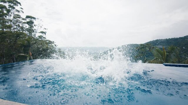 Couple runs with camera and jumps into the private pool. Influencers film a video with selfie stick