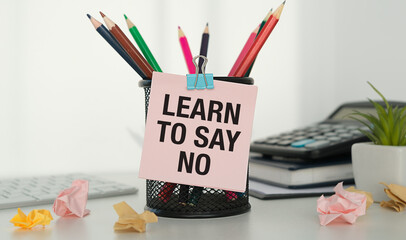 Learn to say no - concept of text on pink sticky note. Work and study concept