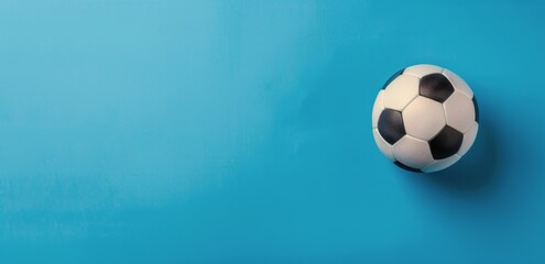 Obraz premium Black and White Soccer Ball on Blue Background