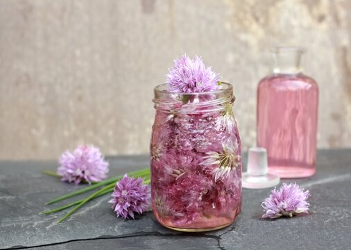 Seasoned vinegar with chive flower heads...Herb infused in vinegar can be used to flavour salads and meals.