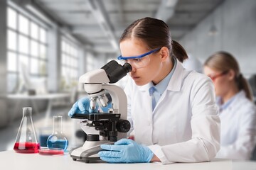 Oncology doctor do examining sample under microscope,