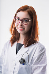 Woman in lab coat, glasses, smiling warmly