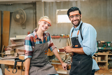 Obraz premium professional artisan carpenters woodworking team work together creatively, creative carpenter woman working workshop for wooden craft with wood tool at industry carpenter's shop, business of wood