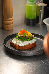 Toast with avocado and red caviar