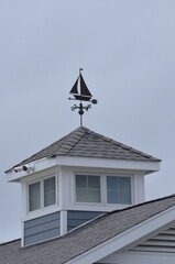 Sailboat weathervane on a boat house roof
