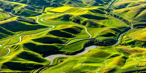 Aerial view of lush green valley with river running through it.