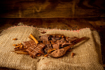 Variety of spiced chocolates on rustic background