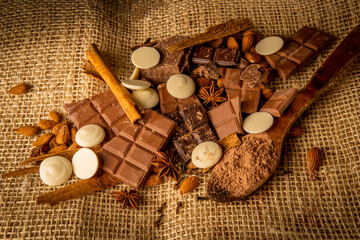 Overhead photograph of various chocolates, sweet bitters and whites with spices