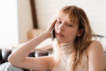 Caucasian young woman talking on phone , doing online shopping, communicating with friends with...