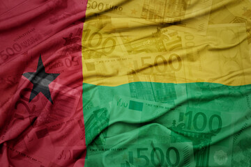 waving colorful national flag of guinea bissau on a euro money banknotes background. finance concept.