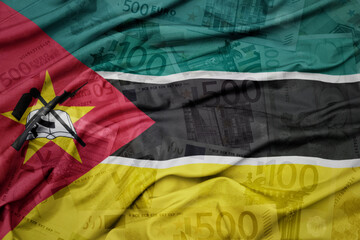 waving colorful national flag of mozambique on a euro money banknotes background. finance concept.