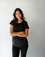 Obraz premium Beautiful natural brunette woman, smiling and looking in camera with white teeth. Close-up portrait of cute female woman in black t-shirt on white background. 