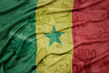 waving colorful national flag of senegal on a euro money banknotes background. finance concept.