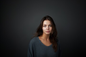 Fototapeta premium Portrait of an attractive woman on a gray background. Female beauty.