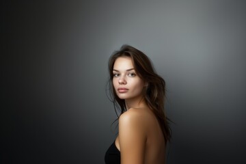 Fototapeta premium Portrait of an attractive woman on a gray background. Female beauty.