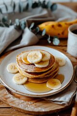Obraz na płótnie Canvas Stack of Pancakes With Bananas and Syrup