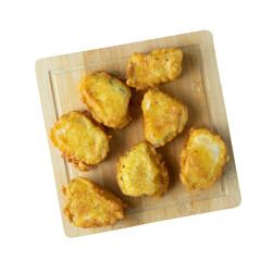 Pieces of battered and fried cod on a bamboo kitchen board.
