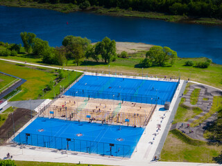 Outdoor basketball, tennis and volleyball courts in Nemunas island, Kaunas. Aerial panoramic drone photo