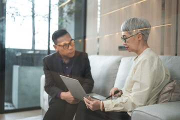 Asian businessman present start up project to expert investor, Teamwork group of multicultural business team solving problems, discussing business idea with skyscraper at modern business lounge