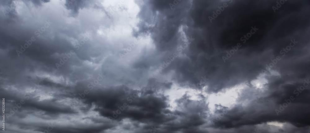 Wall mural The dark sky with heavy clouds converging and a violent storm before the rain.Bad or moody weather sky and environment. carbon dioxide emissions, greenhouse effect, global warming, climate change.