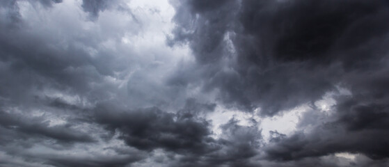 The dark sky with heavy clouds converging and a violent storm before the rain.Bad or moody weather...