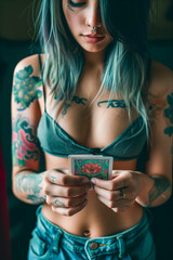 Woman with tattoos holding a card