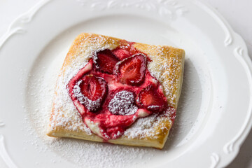 Puffs with strawberries and strawberries. The process of making summer dessert