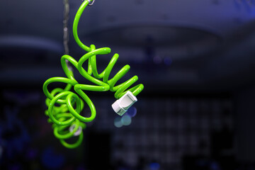 Electric socket on a green coiled cord dangling from the ceiling
