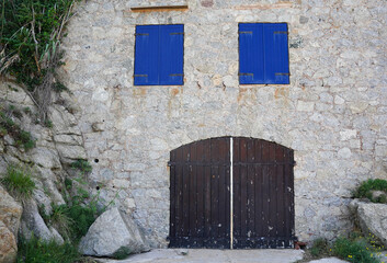 Pareidolia, a face in the stone house made with two window and one door